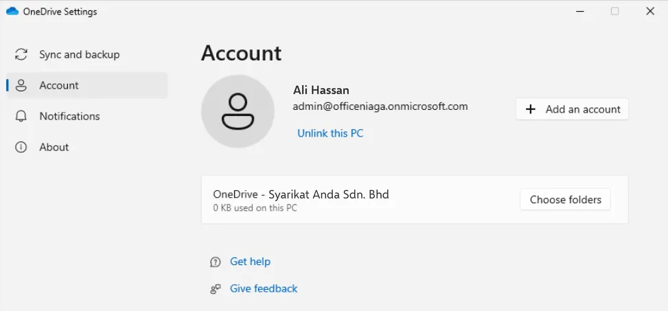 OneDrive Settings on the Account tab showing the work account and the Unlink this PC link